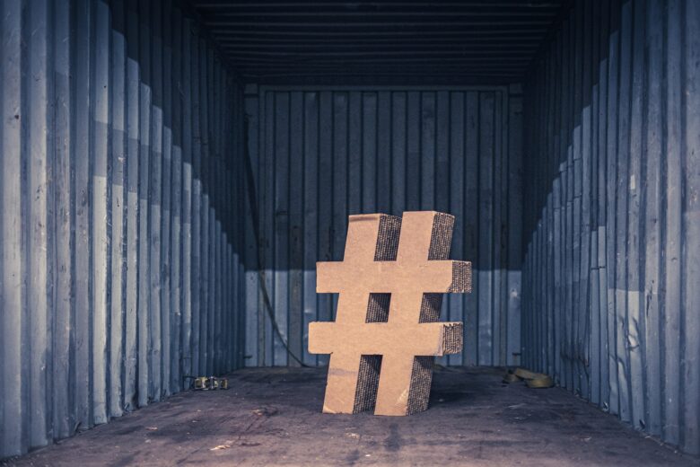 a wooden hashtag in front of an aluminium wall