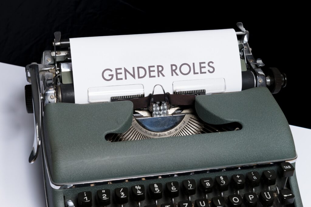typewriter with a white sheet saying gender roles