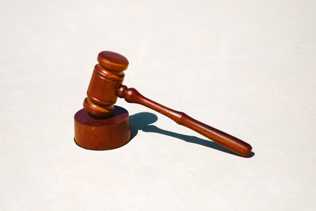 A judge's gavel in front of a white background