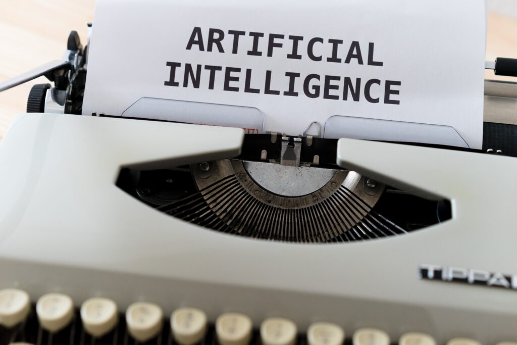 A typewriter with a paper saying AI (artificial intelligence)